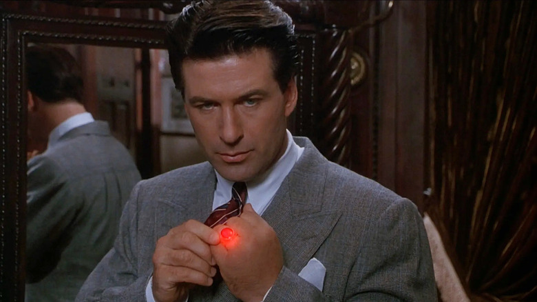 Alec Baldwin as Lamont Cranston fiddles with his glowing ring in The Shadow