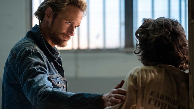 Alexander Skarsgård as Randall Flagg in The Stand, wearing a denim jacket