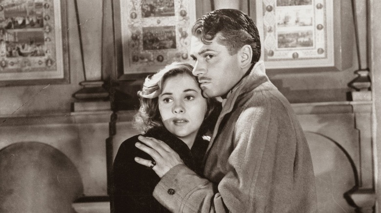 Joan Fontaine and Laurence Olivier huddle together