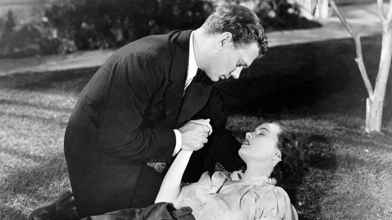 Joseph Cotten holds young lady's hand