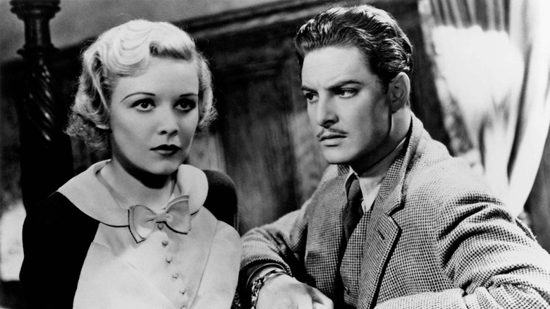 Robert Donat eyes Madeleine Carroll suspiciously