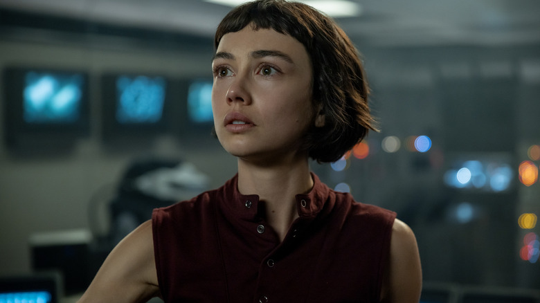 Sydney Chandler as Wendy standing in a room full of computer equipment and looking at a screen in Alien: Earth