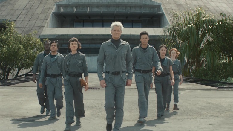 Jonathan Ajayi as Smee, Adarsh Gourav as Slightly, Sydney Chandler as Wendy, Timothy Olyphant as Kirsh, Kit Young as Tootles, Erana James as Curly and Lily Newmark as Nibs purposefully stride out of a building in Alien: Earth