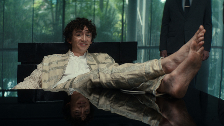 Boy Kavalier sitting with his feet up on his desk in Alien: Earth