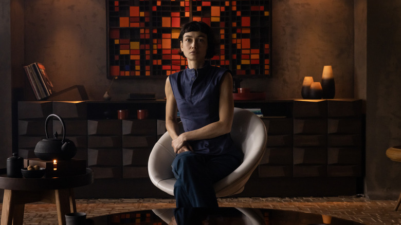 Wendy sitting in a chair with a tea kettle beside her in Alien: Earth