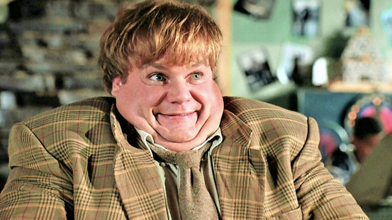 Chris Farley sitting in Tommy Boy