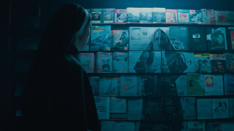 The Nun materializes via the pages of magazines at a newsstand in The Nun 2