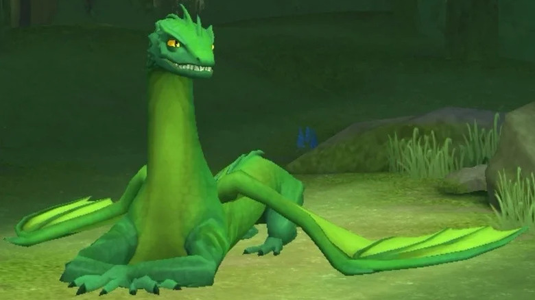 A Common Welsh Green reclines in the grass in Harry Potter: Hogwarts Mystery