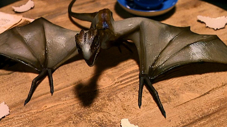 A freshly hatched Norwegian Ridgeback looks up from a table in Harry Potter and the Sorcerer's Stone