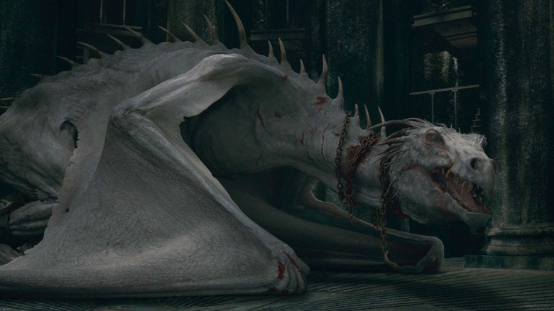 A Ukrainian Ironbelly bursts through a bank with fire breath and wizards on its back in Harry Potter and the Deathly Hollows: Part 2