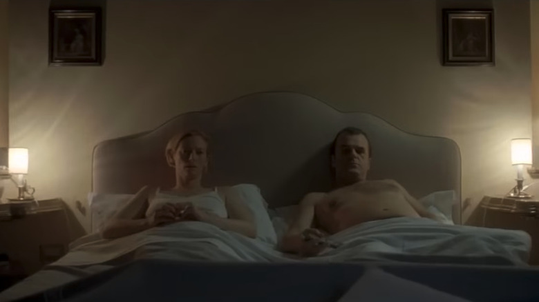 Tilda Swinton and Pippo Delbono as Emma and Tancredi Recchi, sitting in bed together in I Am Love
