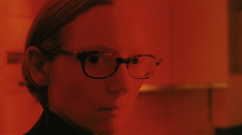 Tilda Swinton as Actress, bathed in red light in The Protagonists