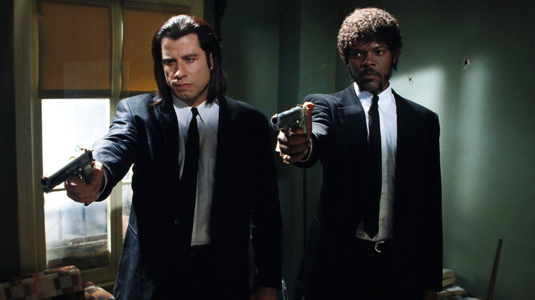 John Travolta's Vincent Vega and Samuel L Jackson's Jules Winnfield pointing guns in an apartment in Pulp Fiction