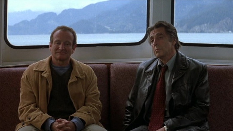 Robin Williams as Walter Finch and Al Pacino as Will Dormer sitting side by side in the interior of a boat out on the water in Insomnia.