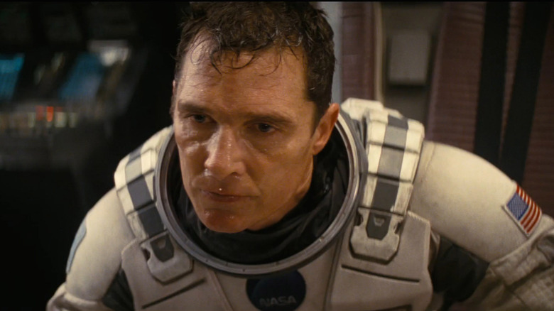 Matthew McConaughey as Joseph "Coop" Cooper in Interstellar, suited up in his astronaut gear, looking intently out of frame.