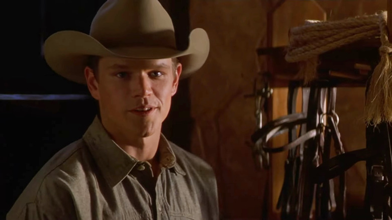 John Grady (Matt Damon) smiling in a horse stable in All the Pretty Horses