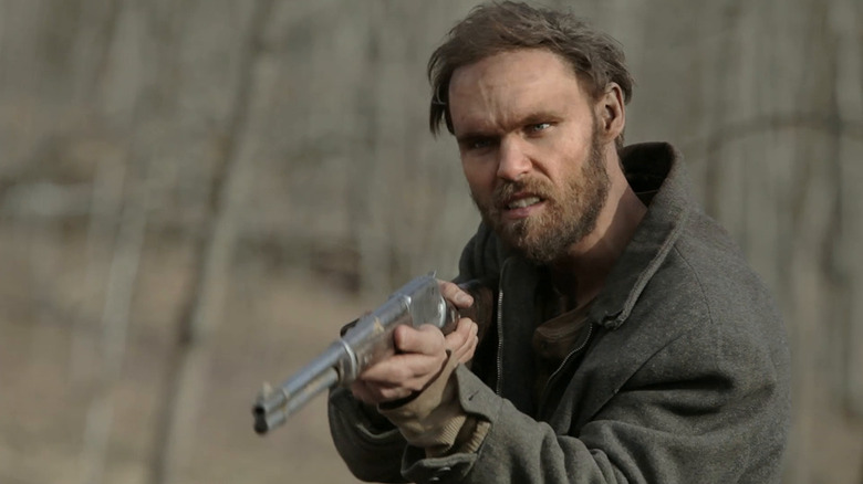 Lester Ballard (Scott Haze) aims a rifle in Child of God
