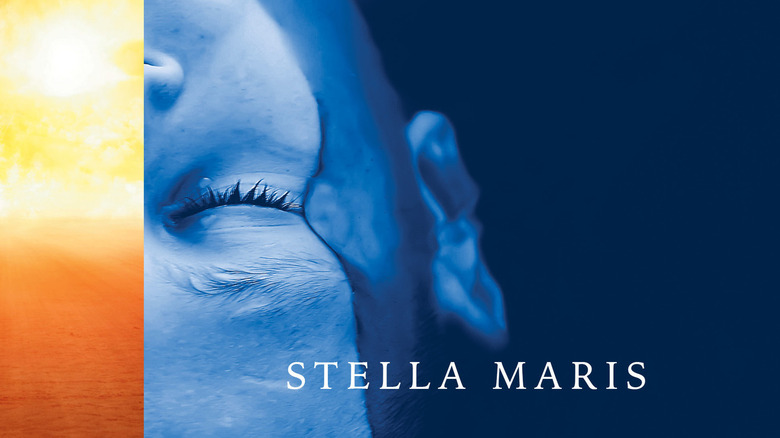 A woman's face is partially submerged in water on the cover of Stella Maris