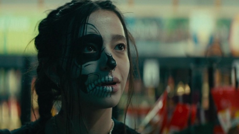 Mikey Madison as River wearing skull makeup on half her face in All Souls