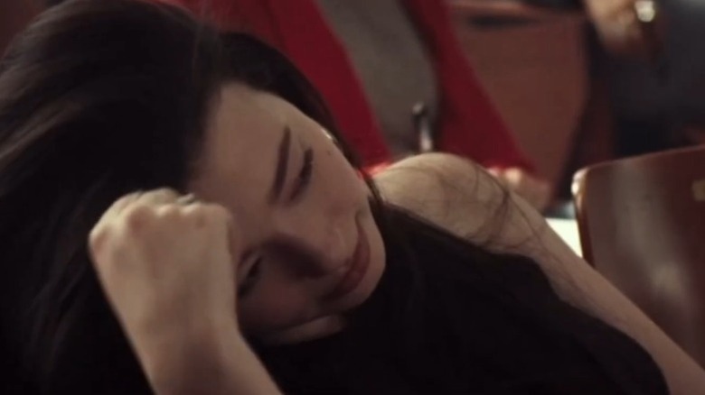Mikey Madison as Alexandra Floyd sitting in class and tilting her head to the right in Monster