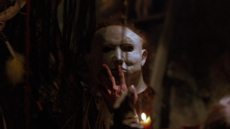 A reflection of Michael Myers (Don Shanks) touches his mask in Halloween 5: The Revenge of Michael Myers