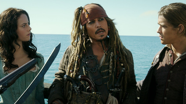 Kaya Scodelario, Johnny Depp, and Brenton Thwaites as Carina Smyth, Captain Jack Sparrow, and Henry Turner in Pirates of the Caribbean: Dead Men Tell No Tales