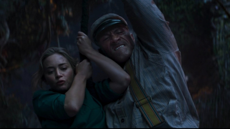 Emily Blunt and Dwayne Johnson as Lily Houghton and Frank Wolff as they swing through the trees in Jungle Cruise