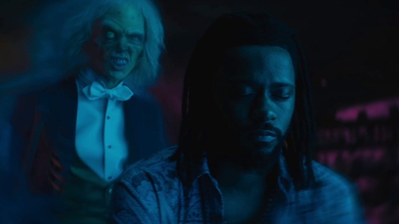 LaKeith Stanfield as Ben Matthias gets stalked by a ghost in The Haunted Mansion
