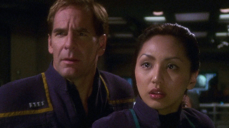 Jonathan Archer (Scott Bakula) and Hoshi Sato (Linda Park) stand shocked in Star Trek: Enterprise