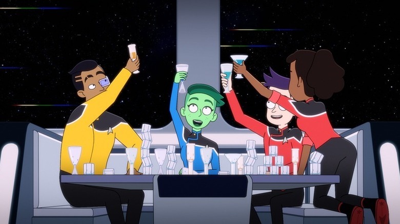 Sam Rutherford (Eugene Cordero), D'Vana Tendi (Noël Wells), Brad Boimler (Jack Quaid), and Beckett Mariner (Tawny Newsome) toast over a crowded table in Star Trek: Lower Decks