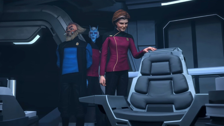 Kathryn Janeway (Kate Mulgrew) approaches a captain's chair in Star Trek: Prodigy