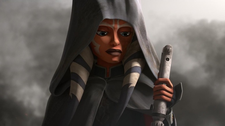 Ahsoka Tano looks at her lightsaber in Star Wars: The Clone Wars