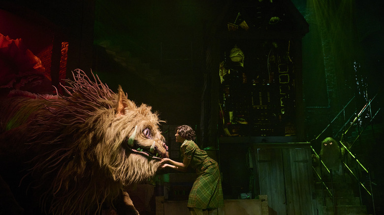 A person encounters a giant magical creature at Le Cirque Arcanus at Epic Universe