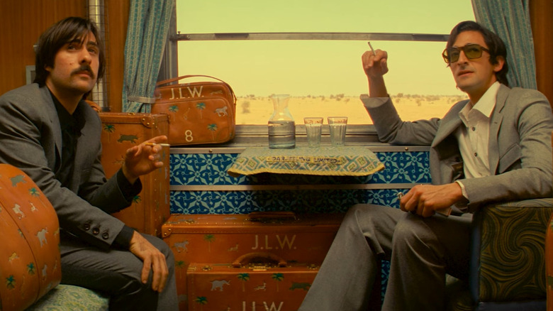Jason Schwartzman and Adrien Brody as Jack and Peter, smoking together on a train in The Darjeeling Limited
