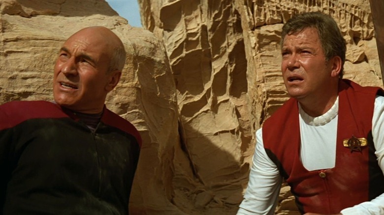 Jean-Luc Picard (Patrick Stewart) and Jim Kirk (William Shatner) look up from a rocky canyon in Star Trek Generations