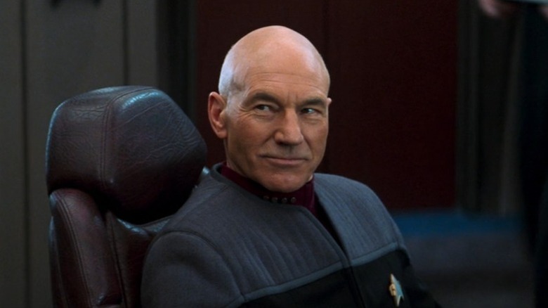 Jean-Luc Picard (Patrick Stewart) smiles from the captain's chair in Star Trek: Nemesis