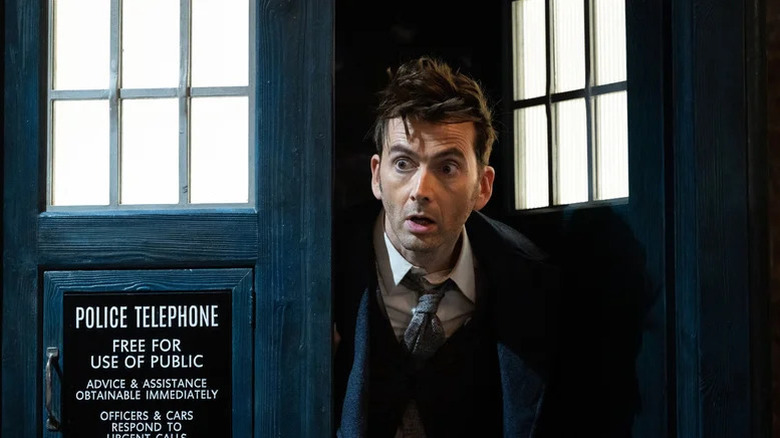 The Fourteenth Doctor (David Tennant) looks shocked outside of the TARDIS in Doctor Who