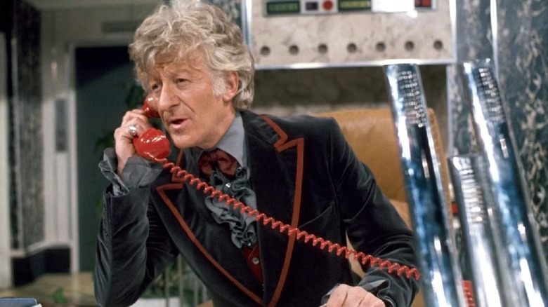The Third Doctor (Jon Pertwee) speaks on a red phone in Doctor Who