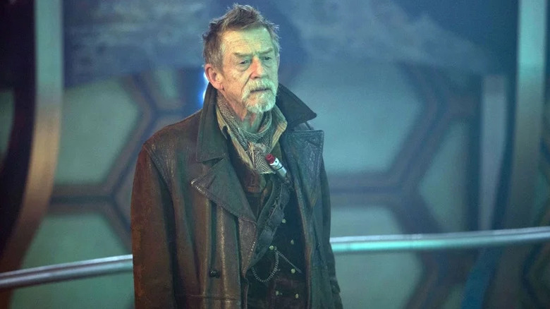 The War Doctor (John Hurt) stands against a metal railing in Doctor Who