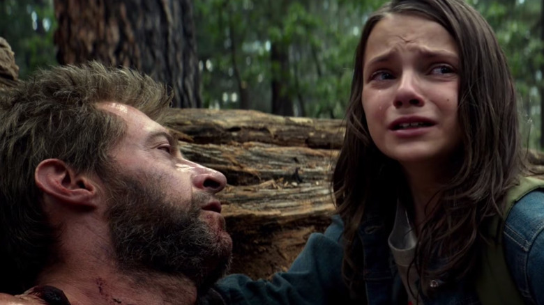 Dafne Keen as Laura/X-23 and Hugh Jackman as a dying Wolverine in Logan