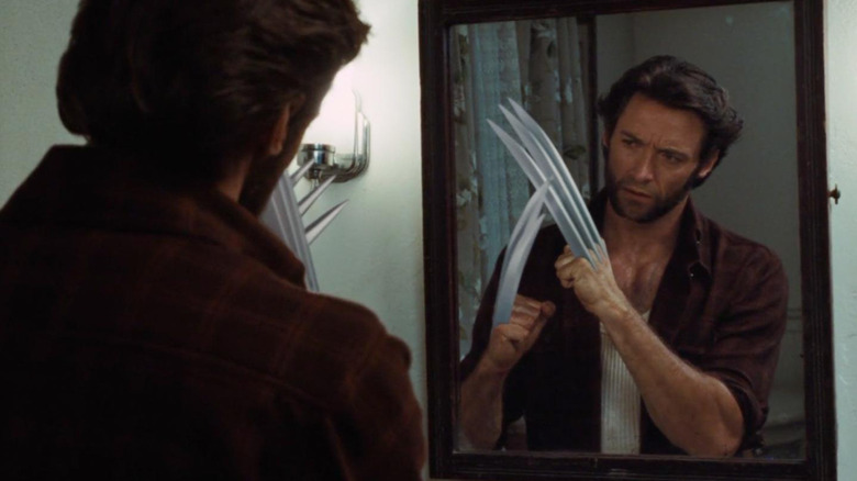Hugh Jackman as Logan examining his claws in a bathroom mirror in X-Men Origins: Wolverine