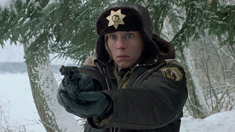 Frances McDormand as Marge Gunderson, aiming a gun in Fargo