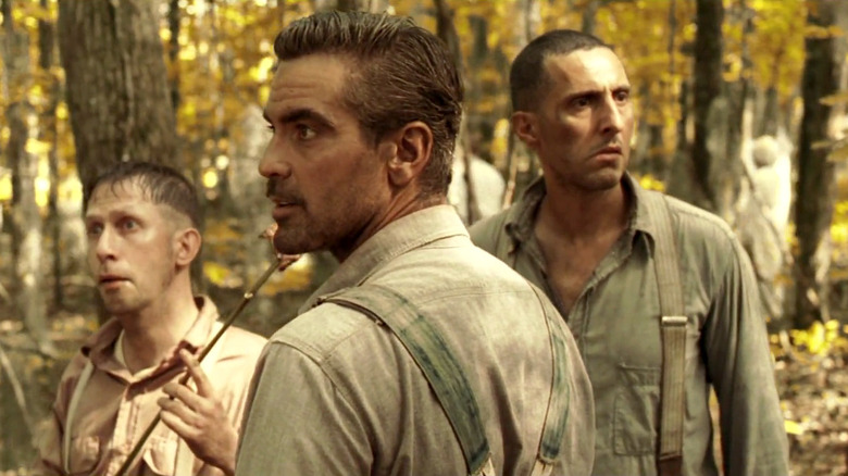 George Clooney as Ulysses Everett McGill, Tim Blake Nelson as Delmar O'Donnell, and John Turturro as Pete Hogwallop on the run in the woods in O Brother, Where Art Thou?