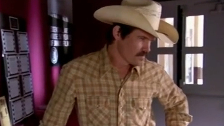 Josh Brolin as Dan, standing at a movie theater in World Cinema