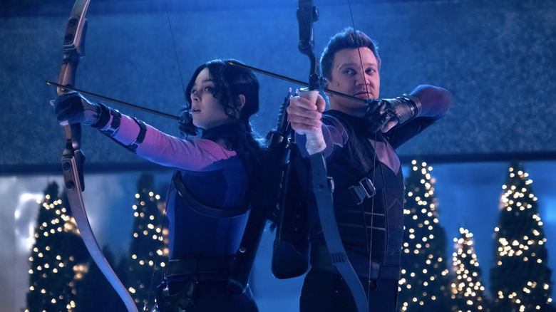 Hailee Steinfeld and Jeremy Renner as Kate Bishop and Clint Barton aiming arrows back to back on Hawkeye