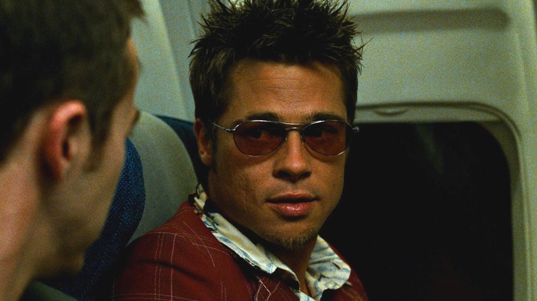 Brad Pitt as Tyler Durden sitting on an airplane next to Edward Norton as the Narrator in Fight Club