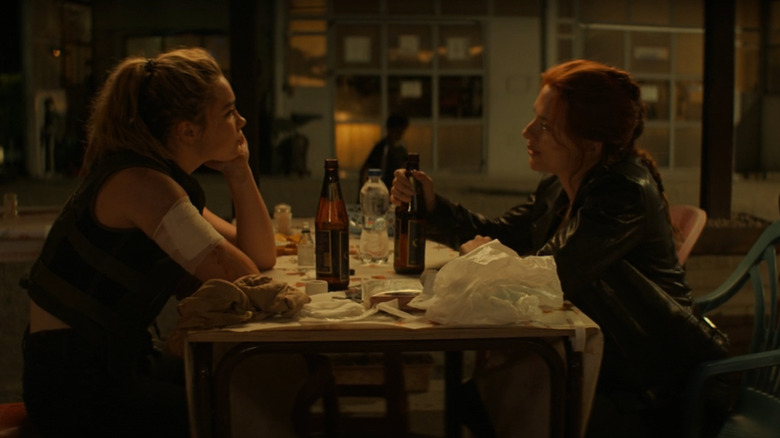 Yelena (Florence Pugh) and Natasha (Scarlett Johansson) sharing a meal in Black Widow