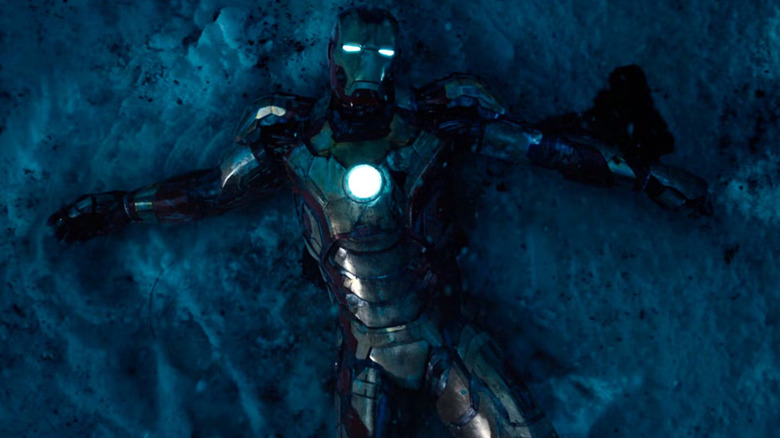 Tony Stark (Robert Downey Jr.) in Iron Man armor, wrecked in the snow in Iron Man 3