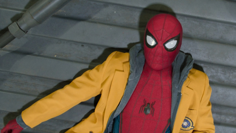 Spider-Man (Tom Holland) lies on floor in his school jacket after being trapped in warehouse in Spider-Man: Homecoming