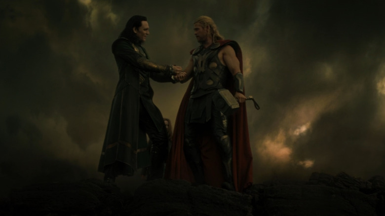 Thor (Chris Hemsworth) and Loki (Tom Hiddleston) shaking hands in Thor: The Dark World